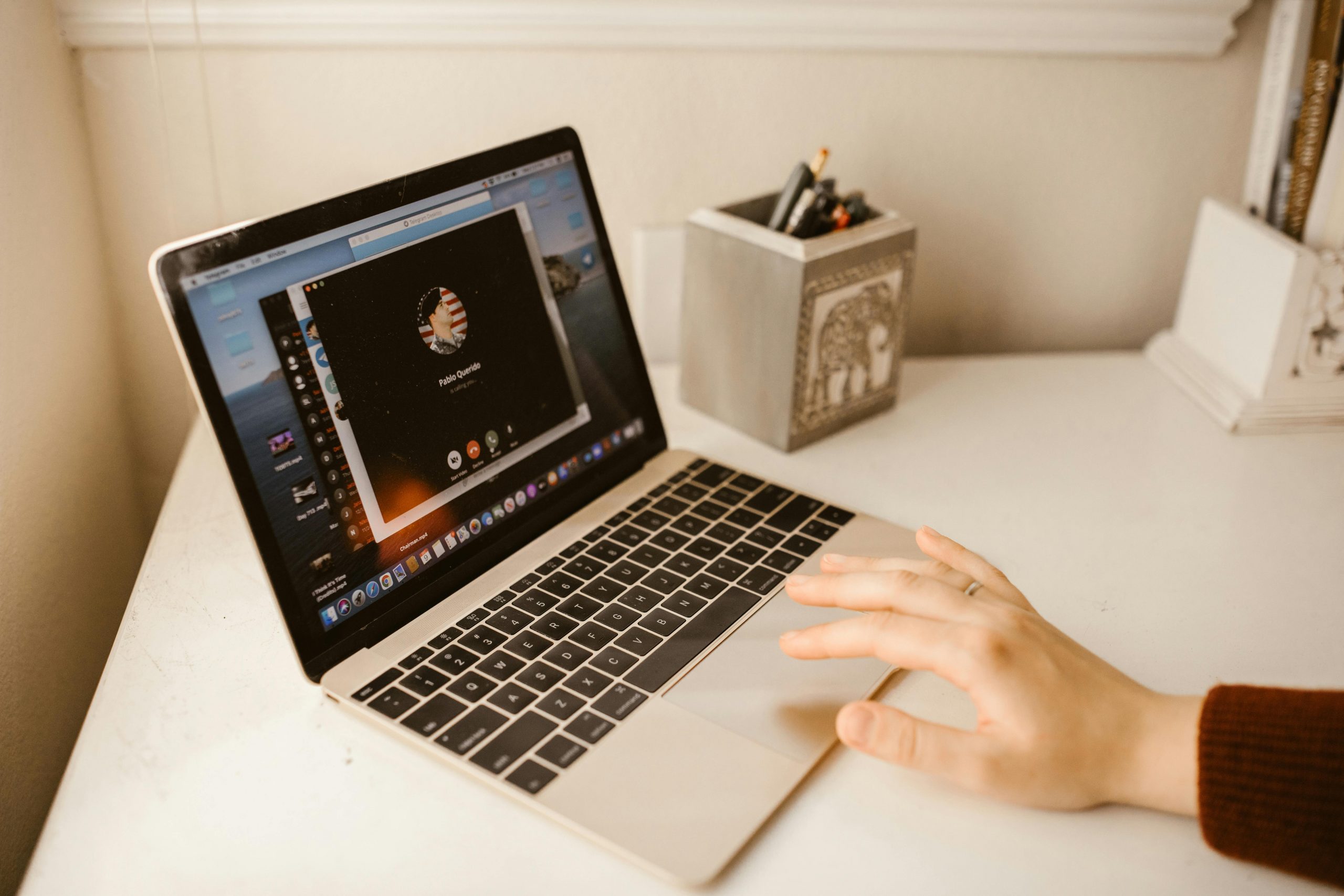 Close-up of a person making a video call on a laptop, showcasing modern communication technology.